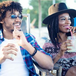 young-happy-black-couple-with-drinks-relaxing-on-7KCXHBR.jpg